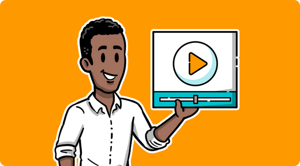 A man holding a video player in his left hand in front of a light orange background.